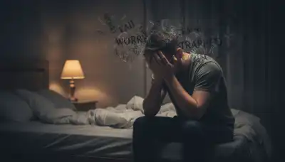 A photorealistic close-up of an exhausted person sitting on the edge of a bed in a dimly lit room, holding their head in their hands. Faint, swirling, chaotic typographic shadows and dark letters seem to surround them in the air, representing a toxic inner monologue and chronic anxiety. Moody lighting, cinematic framing, highly emotional, 8k.