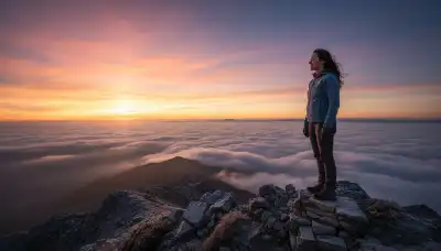 A beautiful, photorealistic image of a person standing on a mountain peak at dawn, looking out over a vast ocean of clouds. The sky is painted in vibrant oranges, pinks, and purples. The person's face is visible in profile, showing a sudden look of deep realization and peace, capturing a profound revelation in a completely wordless state. Epic scale, cinematic lighting, 8k.