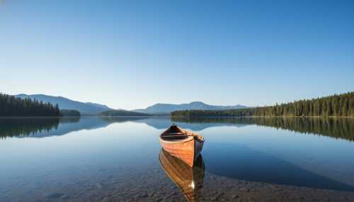 An incredibly beautiful, photorealistic landscape of a simple wooden canoe floating entirely alone on a crystal clear, glass-like lake. The surface of the water perfectly reflects a bright, vast, cloudless blue sky, evoking a deep sense of silence, vastness, and absolute mental peace. Ultra-detailed, natural lighting.