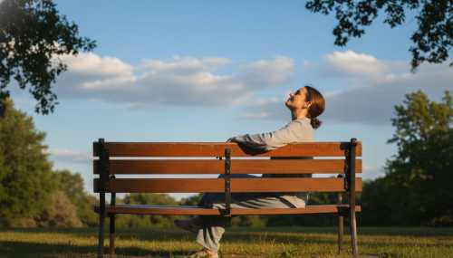 A tranquil scene of an individual sitting peacefully on a wooden park bench, looking up at a vast, bright blue sky with a few fluffy white clouds passing by. The person has a relaxed, unbothered posture, embodying the concept of letting thoughts pass without grabbing them. Warm afternoon sunlight, photorealistic, highly detailed.