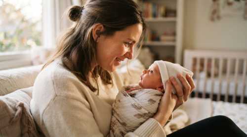 An intimate, close-up photograph of a mother holding her newborn baby in her arms, looking directly into the baby's eyes with deep love and affection. Warm, natural afternoon light filtering through a window, soft focus on the background. Tender, emotional moment, highly detailed skin textures, realistic style.